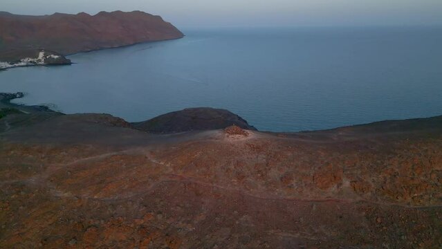 Hiking in Fuerteventura. Acitve Rest. Mountain Top overlooking city at the bottom by the ocean. Playitas Resort.