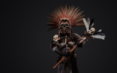 Fototapeta premium Portrait of aboriginal witch dressed in ceremonial attire and plumed headdress.