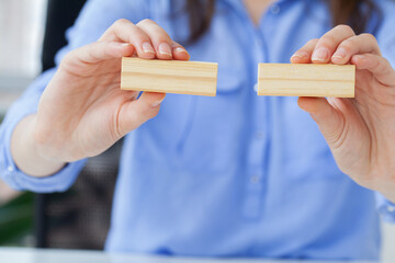 Woman hand of engineer playing a wood block