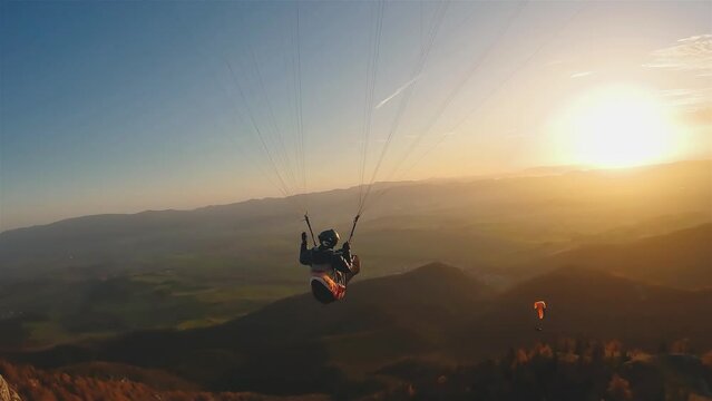 Evening paragliding flight over autumn mountains nature, freedom adrenaline adventure, free like a bird