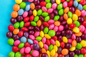 Skittles candy on the colorful table, colorful sweet candy