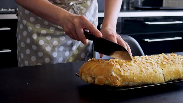 Delicious fresh strudel stuffed with apples and raisins, served with a ball of ice cream, beautiful dessert, black background