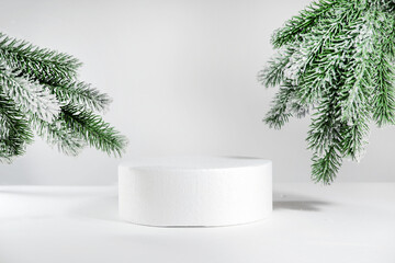 Creative christmas mock up empty podium or pedestal on christmas branch background, with cylinder...