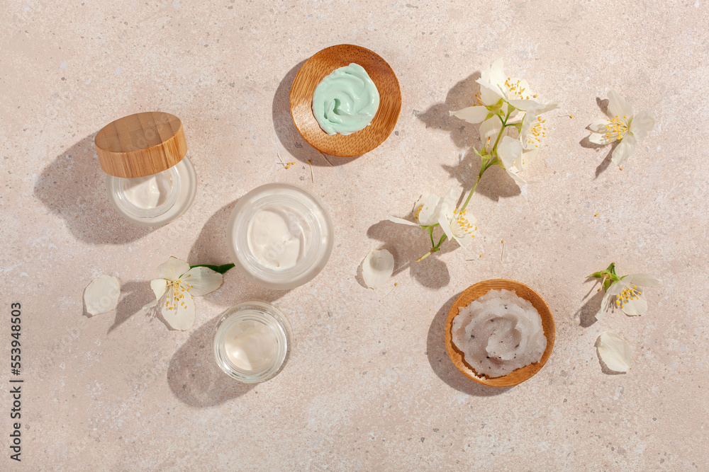 Wall mural skincare products and jasmine flowers. natural cosmetics for home spa treatment