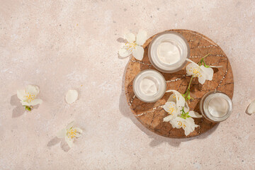 Fototapeta na wymiar skincare products and jasmine flowers. natural cosmetics for home spa treatment