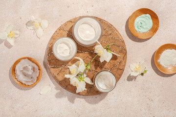 skincare products and jasmine flowers. natural cosmetics for home spa treatment