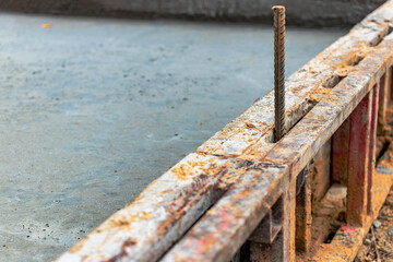Reinforced concrete foundation of a modern monolithic residential building. Prepared formwork with reinforcing mesh for pouring concrete. Monolithic construction technologies.