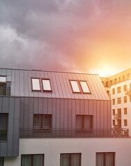 Sunset in modern low-rise flat house district. European contemporary real estate with loft flats.