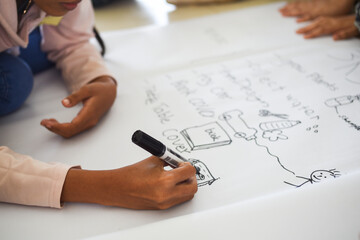 child writing on a white paper learning English 