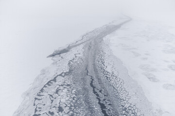 Fototapeta na wymiar A section of the navigable fairway in the ice fields after the icebreaker's passage. Northern Sea Route