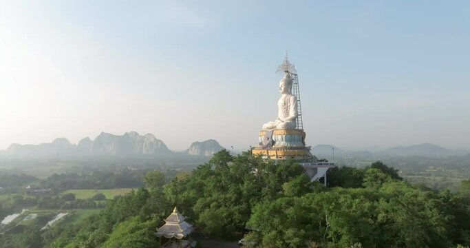 An aerial view of Big Buddha on the mountain stands prominently at Nong Hoi Temple in Ratchaburi near the Bangkok, Thailand.