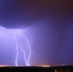 Thunder lightning against purple stormy sky with copy space created using Generative AI technology