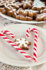 Red striped candies and ginger cookies in the form of a star glaze. Winter New Year's pastries, background