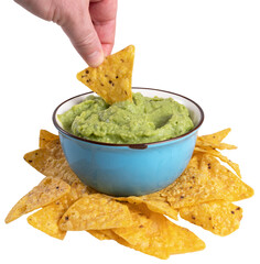 A hand dipping nachos in guacamole sauce