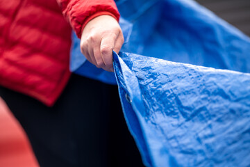 sleeping under a tarp. hiking and camping with a blue tarp - obrazy, fototapety, plakaty