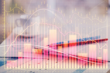 Forex graph hologram on table with computer background. Double exposure. Concept of financial markets.