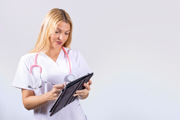 Young nurse with stethoscope writing notes