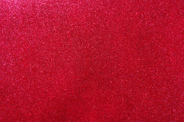 Background with sparkles. Backdrop with glitter. Shiny textured surface. Dark red