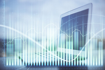 Fototapeta premium Forex Chart hologram on table with computer background. Double exposure. Concept of financial markets.