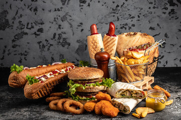 Obraz na płótnie Canvas take away fast food products Kebab, pita, gyros, shaurma, wrap sandwich with french fries and nuggets meal, junk food and unhealthy food. banner, menu, recipe place for text
