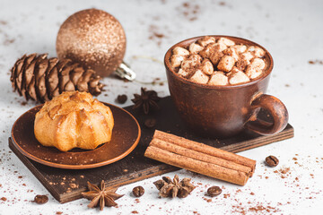 Hot chocolate drink with marshmallows in a cup and sweet bakery eclair dessert sprinkled with cocoa...
