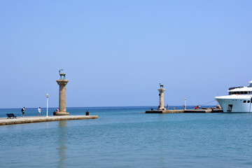 monument of deers on the waterfront of Rhodes island with blue sky and sea on horizon