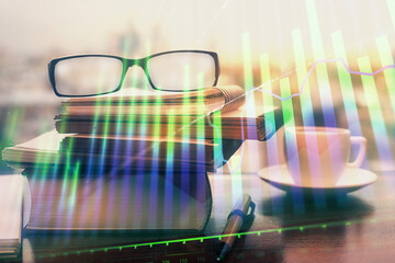 Financial graph hologram with glasses on the table background. Concept of business. Double exposure.