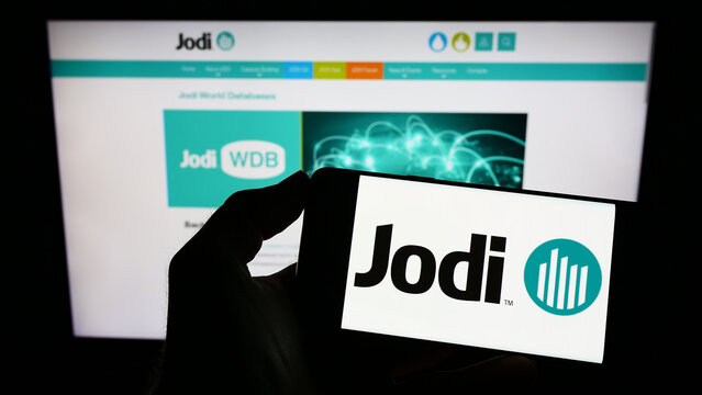 Stuttgart, Germany - 12-03-2022: Person holding cellphone with logo of Joint Organisations Data Initiative (JODI) on screen in front of webpage. Focus on phone display.