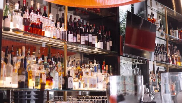 Classy bar with bottles and television, medium