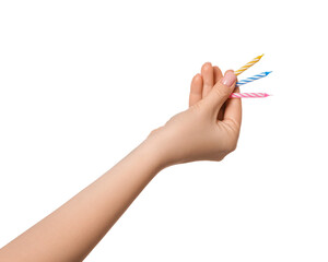 Small multi-colored candles in a female hand, isolate. Birthday candles.