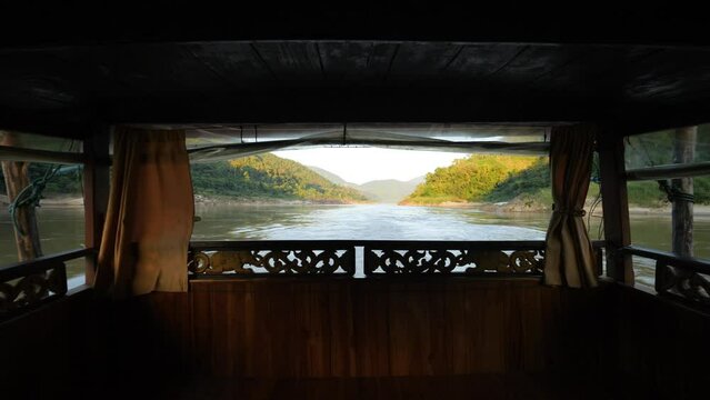 Mekong River Cruise Trip on Slow Wooden Boat from Luang Prabang Rear View High Quality 4K Slowmotion Tourism and Travel in South East Asia Concept Footage. Laos.