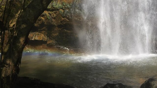 Amazing Wild Rainforest Jungle Waterfall with Rainbow in Water Stream Flow High Quality 4K Slowmotion Cinematic Footage. Thailand.