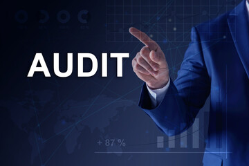 Audit concept. Businessman pointing at graph on dark blue background, closeup. Scheme and world map...