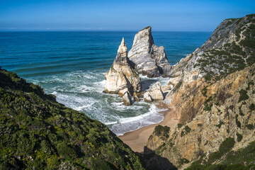 Cliffs, sharp spectacular rocks rising from the ocean. waves. Ursa sandy beach under the cliff....