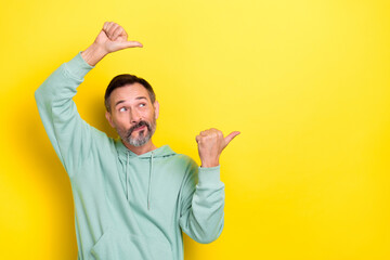 Photo of thoughtful positive optimistic guy dressed mint sweatshirt look indicating empty space...