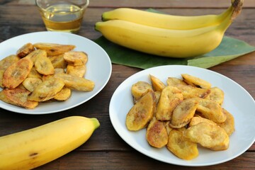 Tasty deep fried banana slices and fresh fruits on wooden table