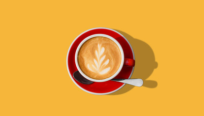 Aromatic coffee in red cup on yellow background, top view