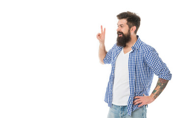 Happy smiling bearded man showing victory peace V sign gesture in casual style studio