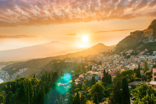highland mediterranean travel landscape scenic picture from green garden to a beautiful mountain town in sunrise or sunset with  trees in garden and amazing colorful sky