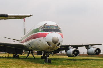 Old destroyed dismantled and abandoned aircraft in the field. Plane crash.