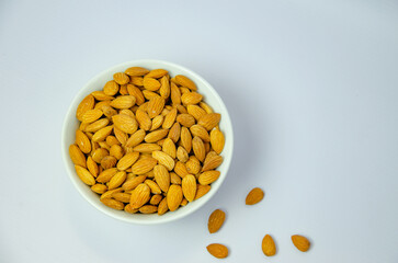 almond nuts in a white plate on a light background