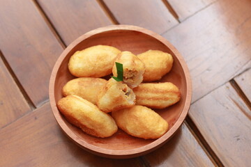 Comro or combro, a traditional Javanese snack made of deep fried grated cassava filled with a savory mix of oncom or fermented soy bean cake and chili