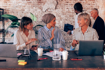 multiethnic female group working together at the desk office