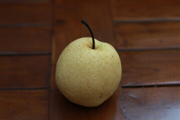 a close up of pear isolated natural pattern wood background. healthy food concept photo. water-rich fruit.