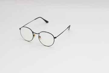 a close up of eyeglasses with black frames isolated on white background