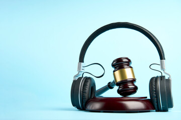 Headphones and judge gavel background with copy-space