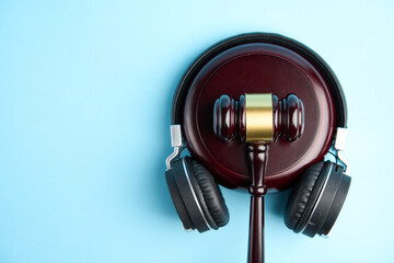 Headphones and judge gavel background with copy-space