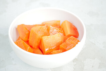 slice of papaya on white plate ,