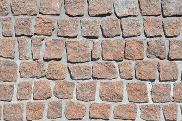 texture of masonry of red granite, natural stone and concrete rows