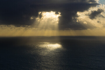 spectacular sunset over the sea with sunlight filtering through the clouds